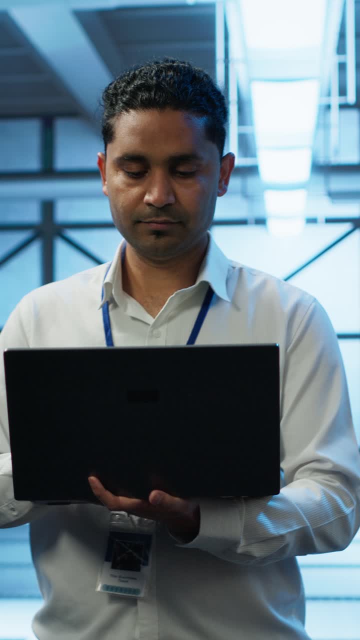 IT Professional Working on Laptop in Data Center