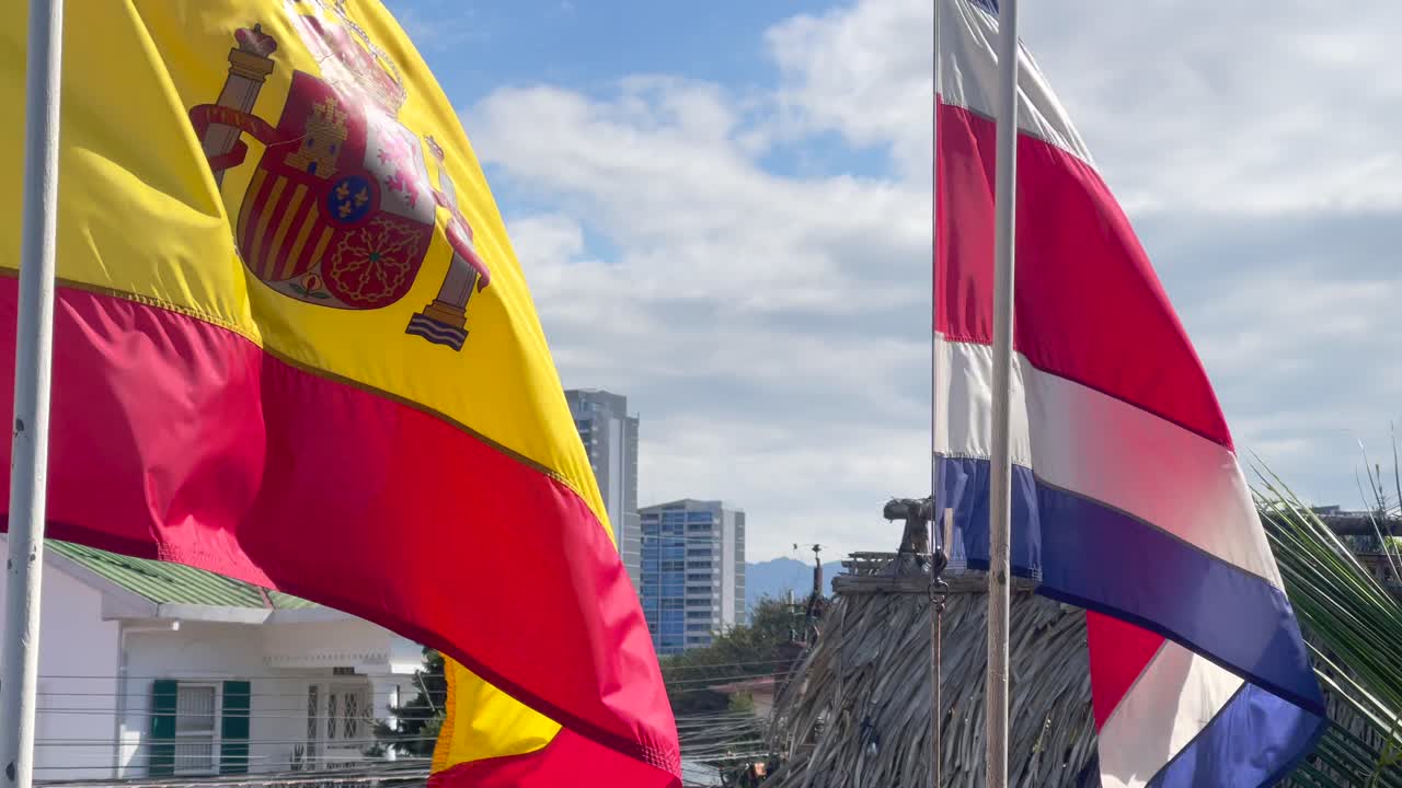Spanish and Costa Rican flags fluttering in slow motion