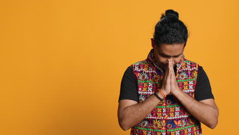 spiritual person doing worship hand gesturing, studio background