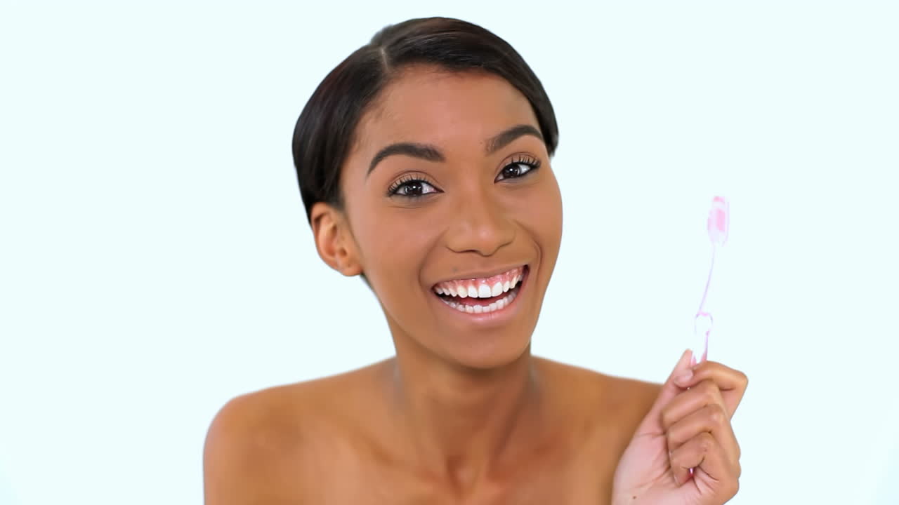 Woman dancing while holding a toothbrush