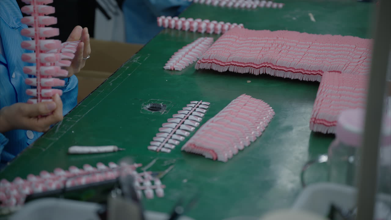 Machine-made artificial nails are inspected by hand in a Chinese factory