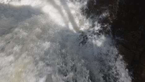 Rushing-waterfall-cascading-down-rocks-in-Owen-Sound,-Canada,-aerial-view