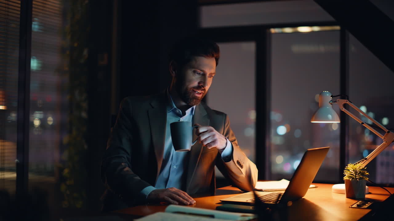 Busy employee writing copybook working project late evening at workplace closeup