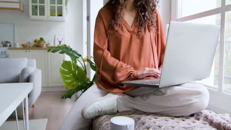 close up view of a woman sitting on the windowsill