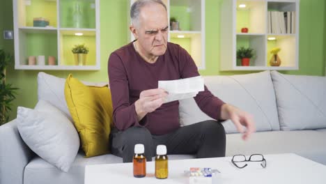 Old-man-examining-a-prescription-for-medicine.