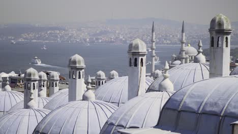 Large-white-domed-buildings-in-a-city-by-the-sea