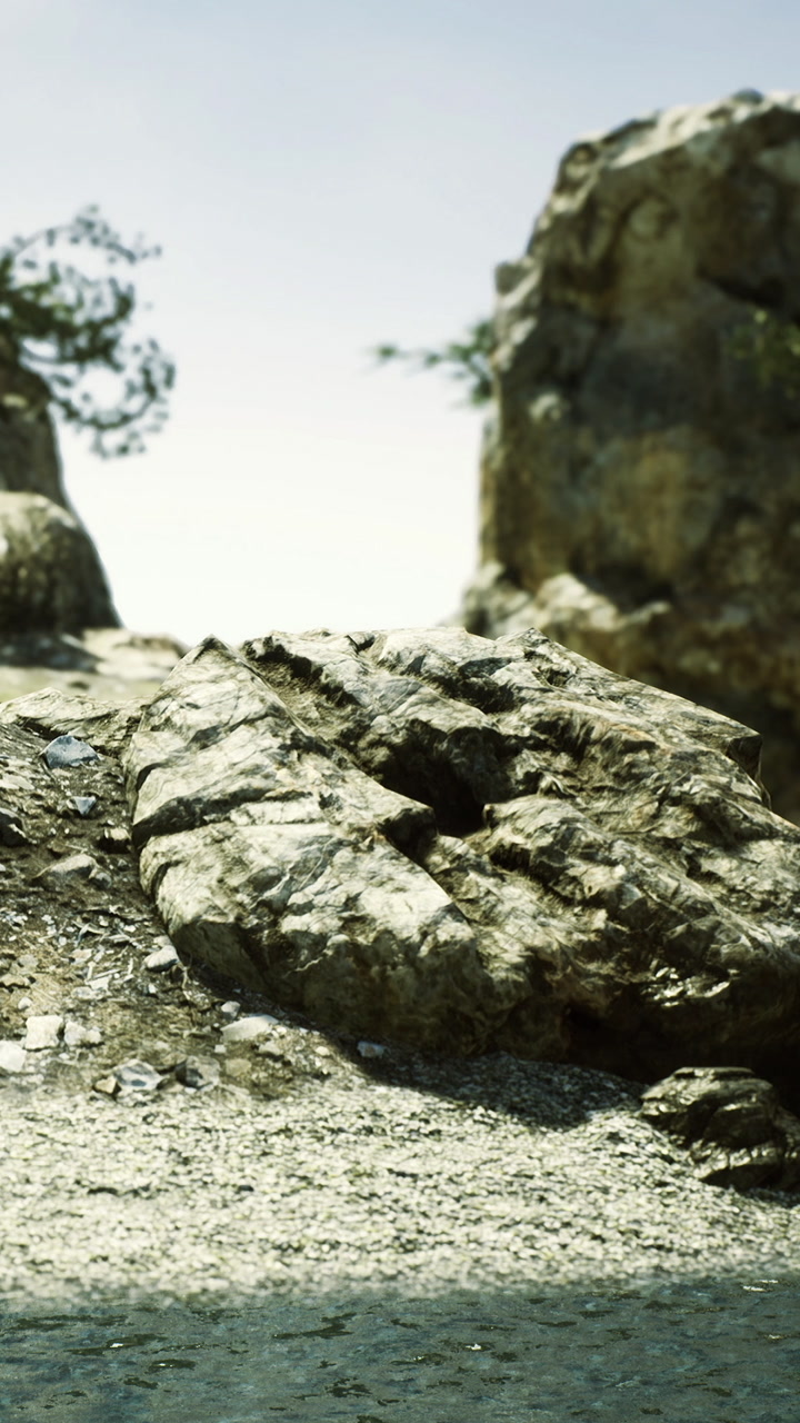 Rocks and water along a shore under a bright sky during the day