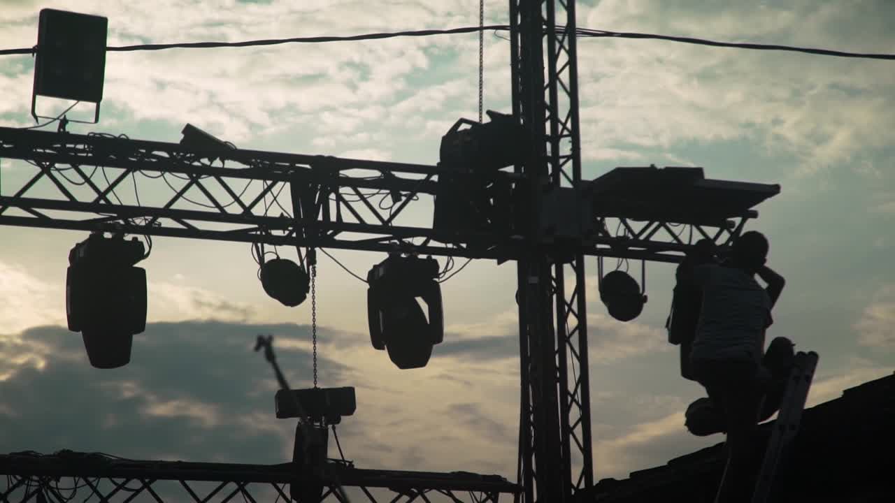 day shot of hanging  at a metal rail concert lights high , sky with white clouds