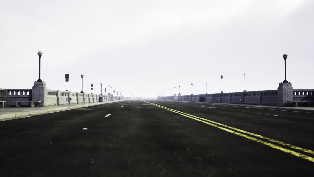 An empty road stretches under a cloudy sky with distant bridge lights