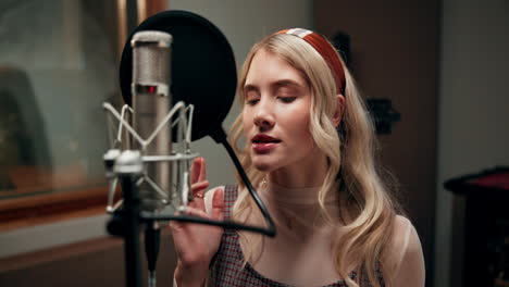 woman singing in a recording studio