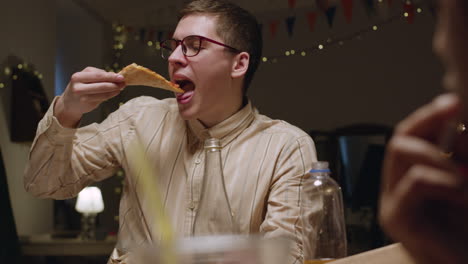 man eating pizza