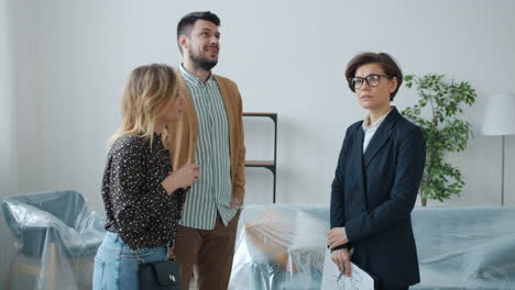 couple viewing new property with real estate agent
