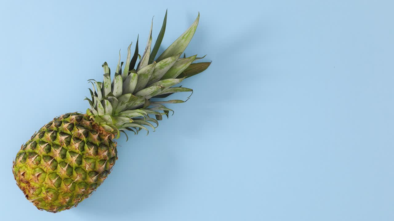 Pineapple spin in place on pastel blue theme. Stop motion