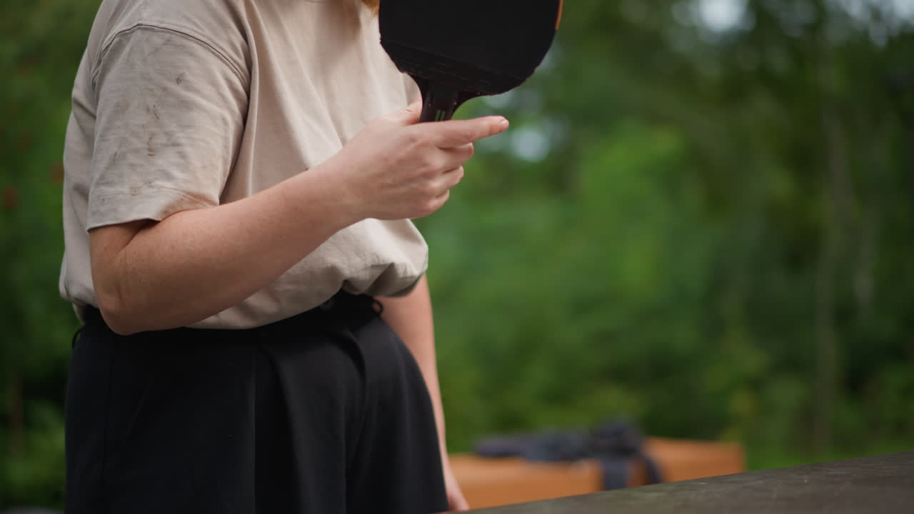 Female Coach Demonstrating, Woman Guiding Player During Relaxed Ping Pong Coaching Session Outdoors, Casual Outdoor Setting Where Female Coach Demonstrates Ping Pong Stroke With Patience