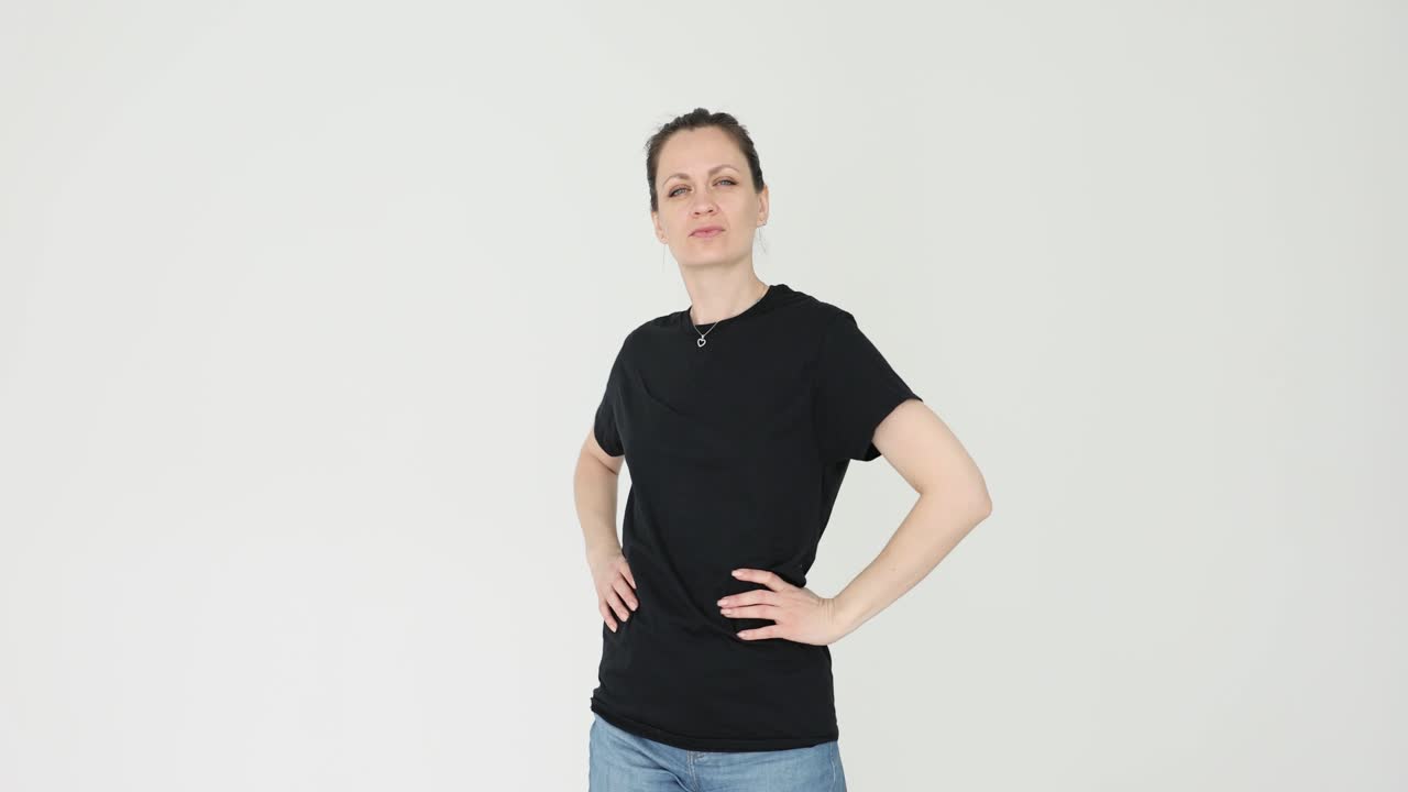 Portrait of a confident woman in a black t-shirt and jeans