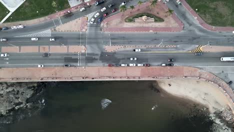 aerial-top-down-of-traffic-avenue-street-road-route-bridge-over-the-ocean-with-cars-and-parking,-controlling-smog-co2-emission