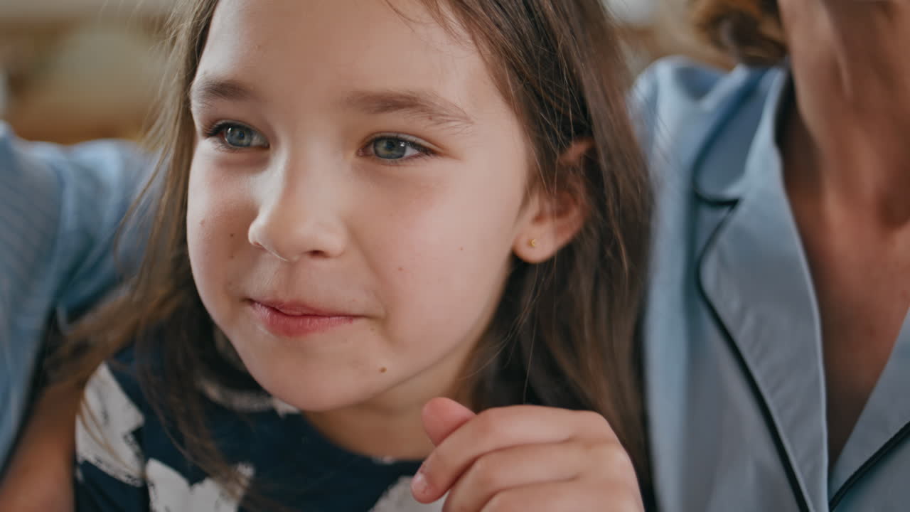 Laughing child eating popcorn at sofa portait. Funny little kid watching comedy