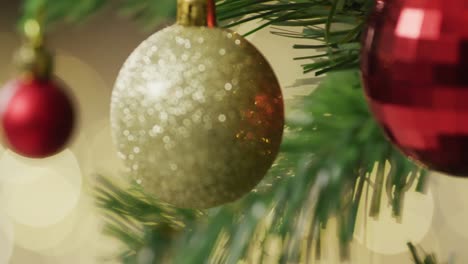 video of christmas tree with baubles and out of focus fairy lights background