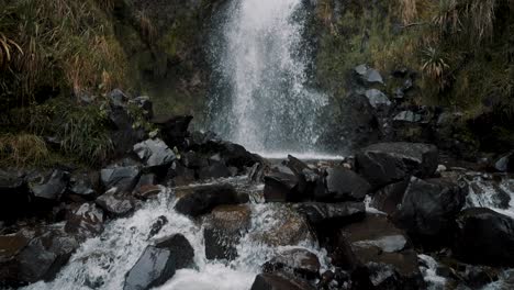 cascading waterfall in cayambe coca national park in papallacta, ecuador - tilt up