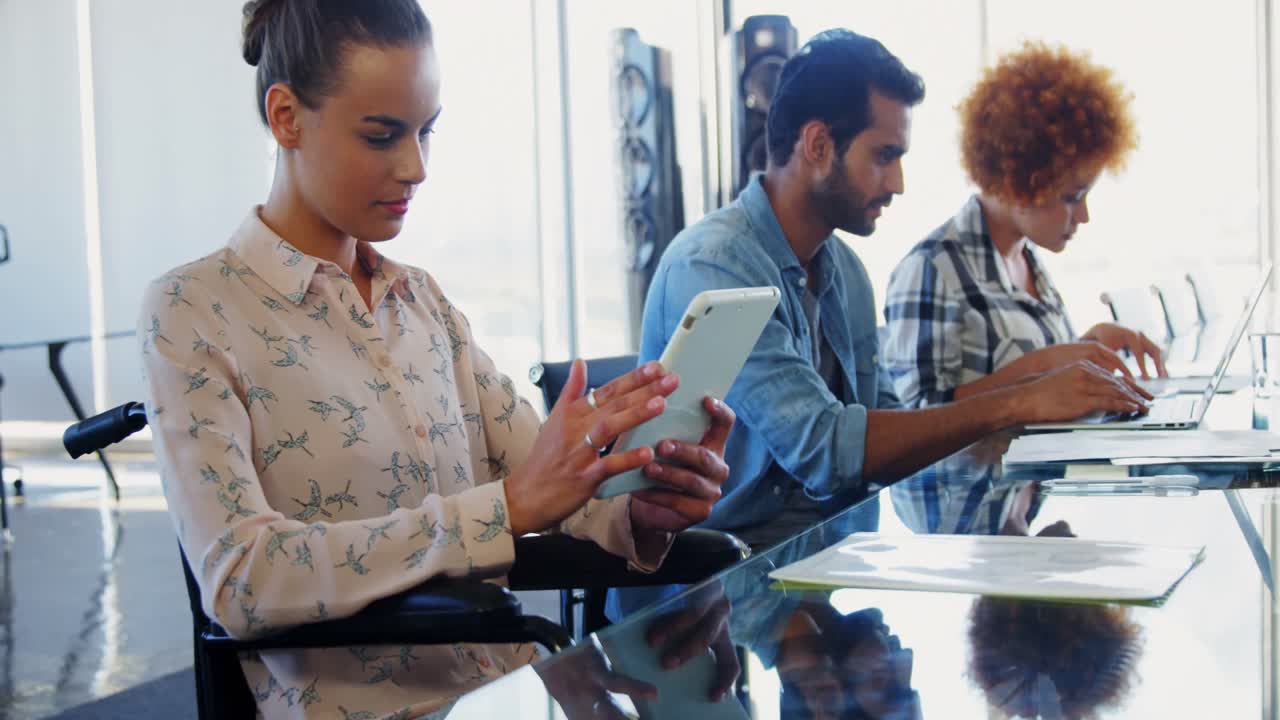 Executives working on electronic gadgets in office