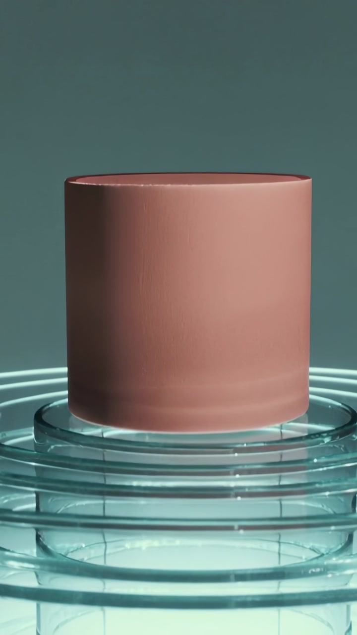 Vertical video: Motor spinning tube on glass rings in teal set for product with cool underlit base