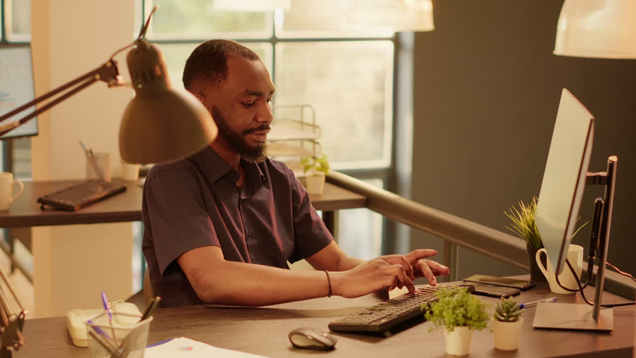 Man working on computer at desk in office