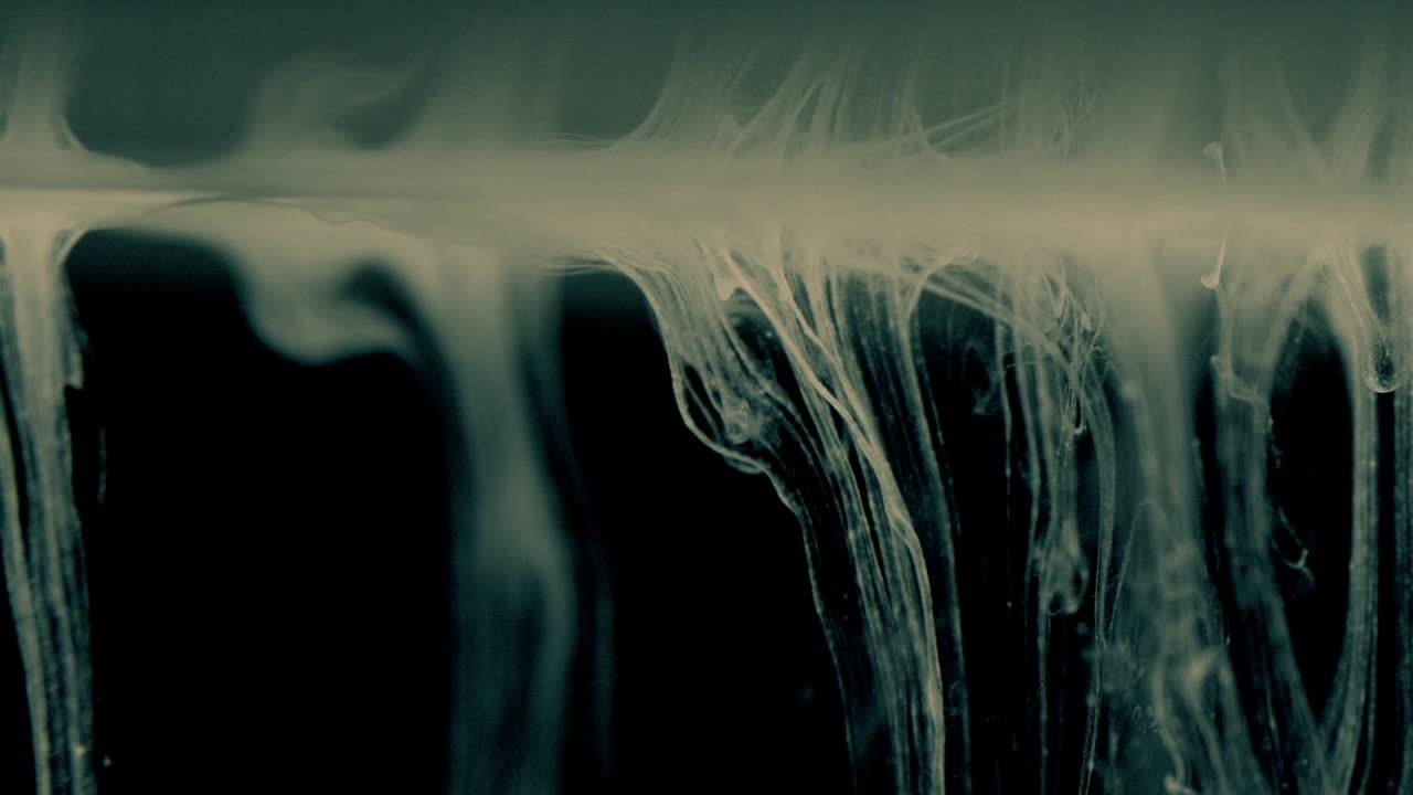 White Ink Effect In Water Filmed On Black Background