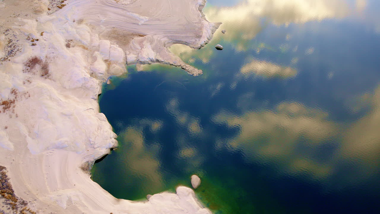 A cinematic drone view soaring over the surreal red rock landscape and arid desert near Lake Powell.