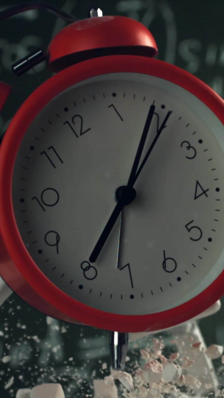 Time Passing on a Red Alarm Clock with Math Equations on a Blackboard