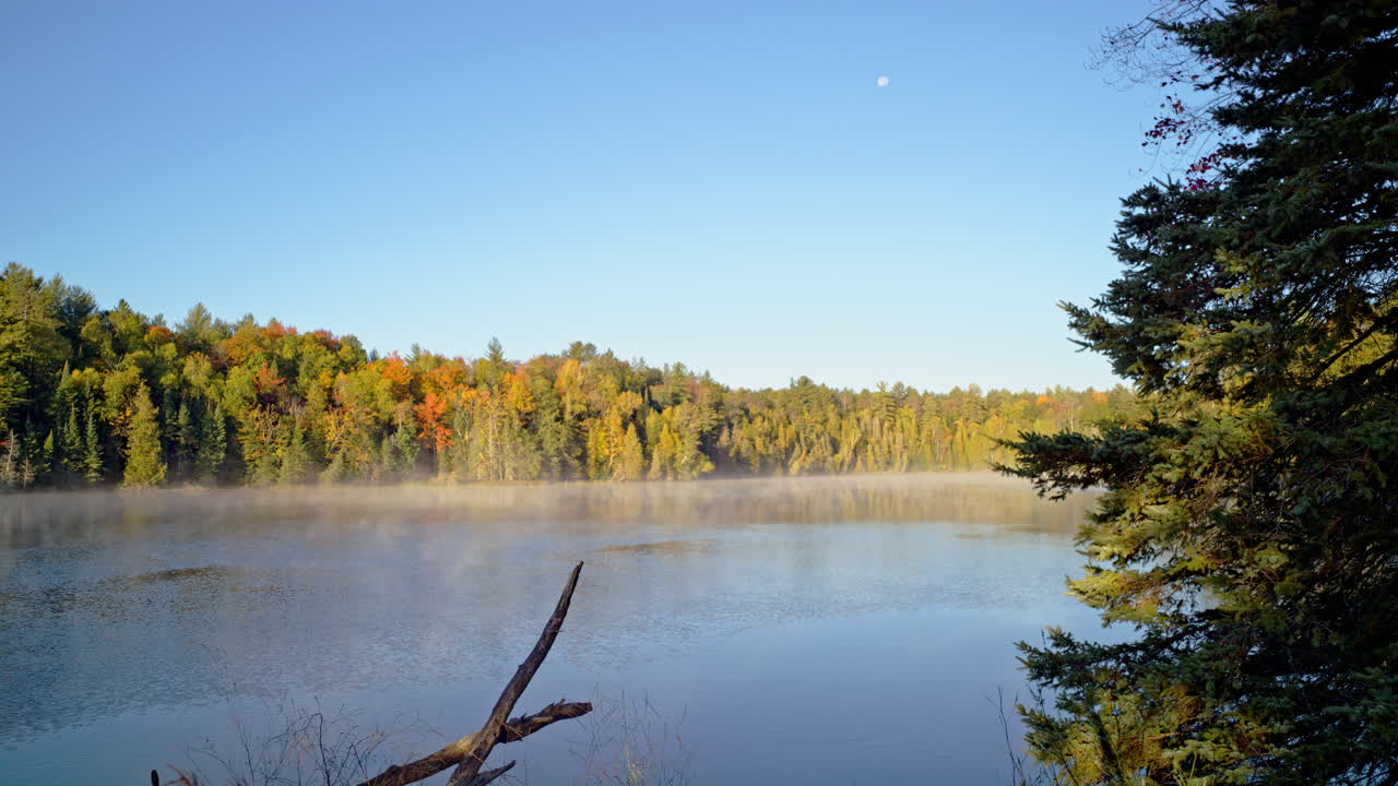 Cinematic wide shot of the Au Sable River with mist at early morning
