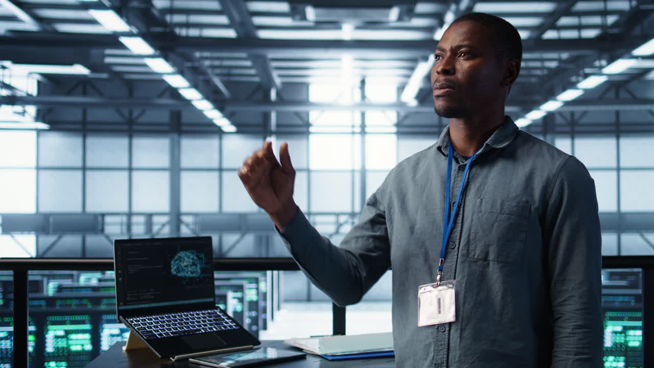 Computer scientist looking at holograms in data center, using AI