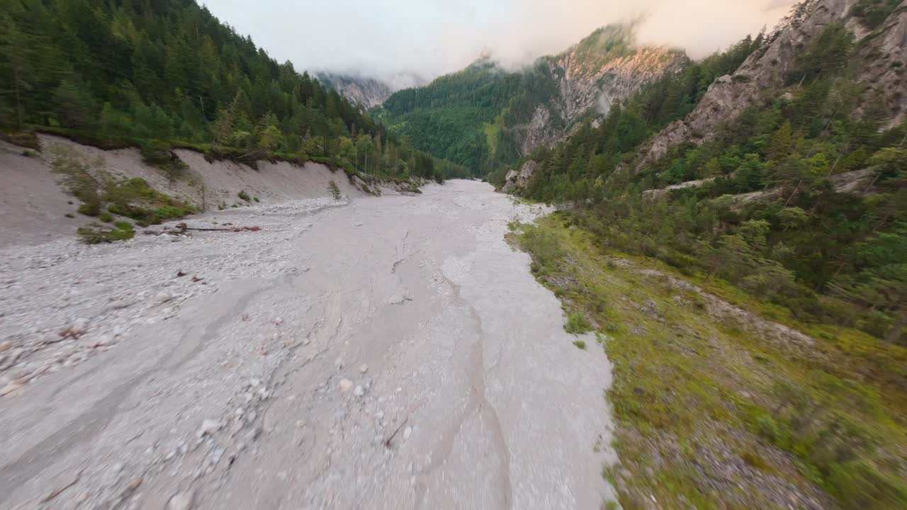 Empty riverbed in Austrian Alps caused by climate change, aerial perspective
