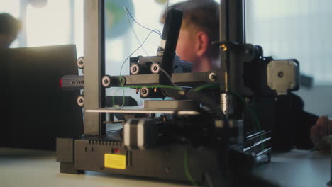 Child using 3D printer in a classroom