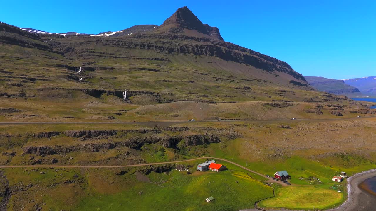 Immerse yourself in the beauty of Djúpivogur’s mountains, with the drone capturing their grandeur and the serene landscapes that surround them.