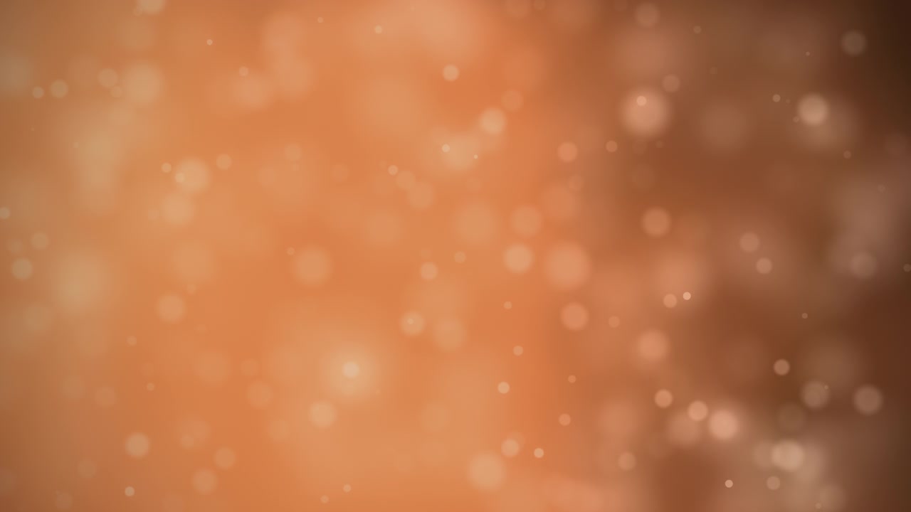 Luci bokeh arancioni fluttuanti offrono una texture di sfondo calda ed elegante per design natalizi stagionali e fondali cinematografici