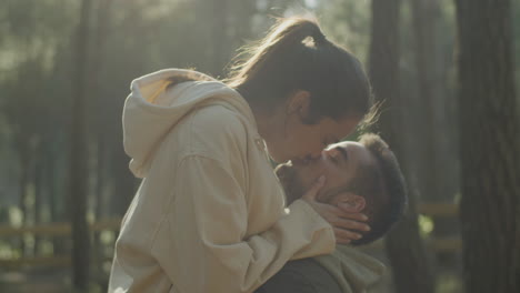 lovely young couple kissing outdoors