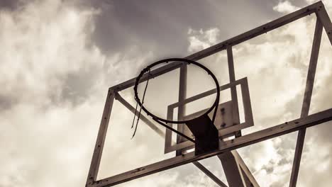 dramatically moving cloud background of a basketball ring in warm color