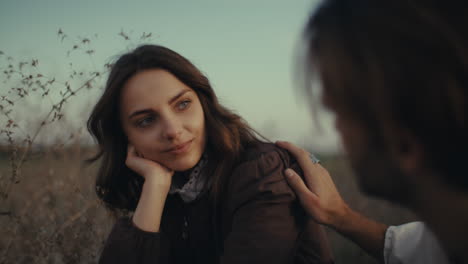 a tender moment between a couple in a field