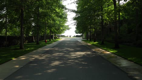 Entrance-way-into-a-beautiful-winery-with-trees-surrounding-each-side-of-the-paved-road-in-Kelowna