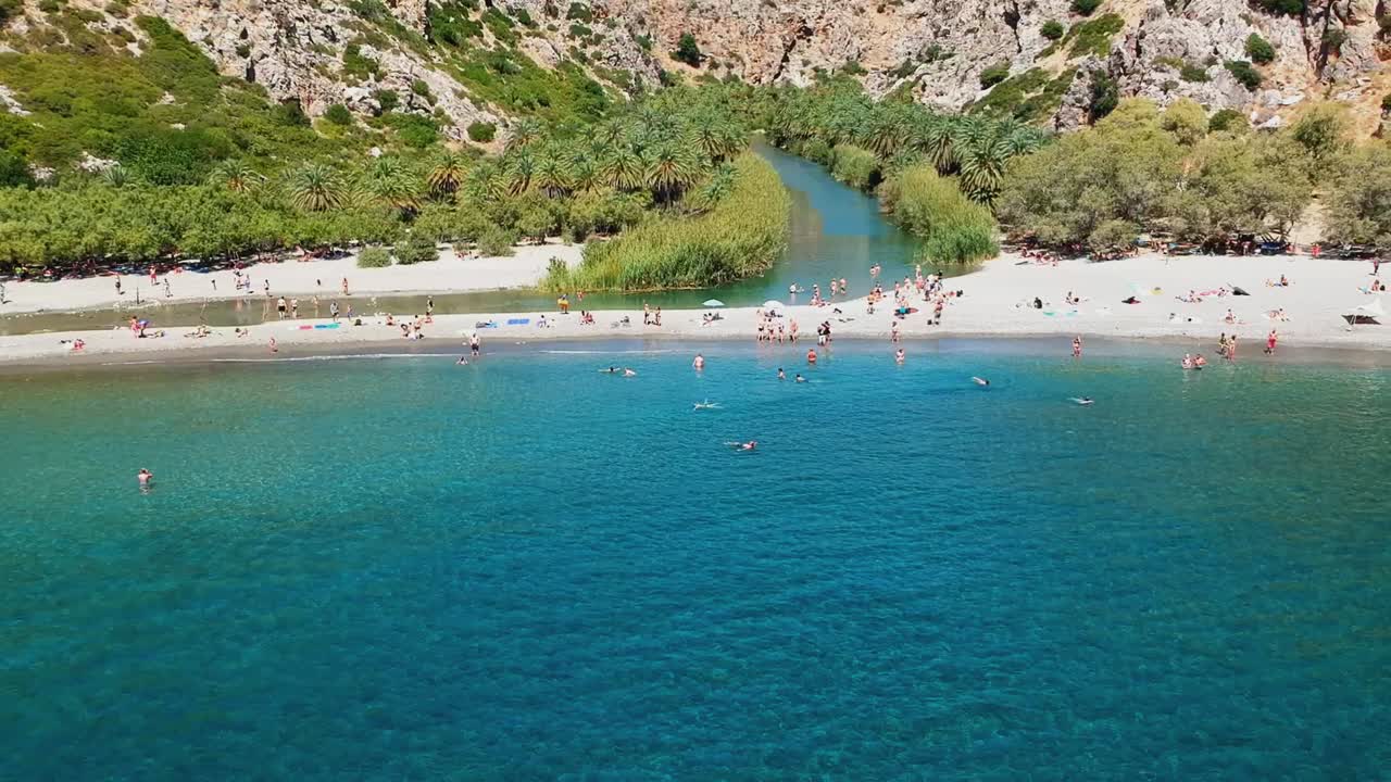 A hidden paradise engulfed in the rocky arms of the gorge and palm forest meeting Preveli beach, Crete