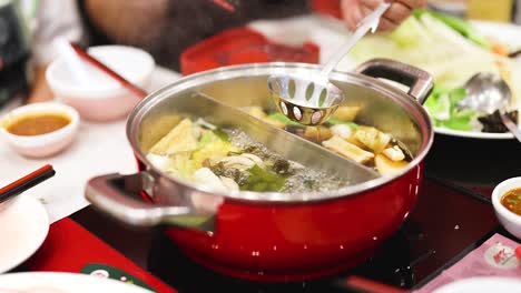 preparing and enjoying hotpot meal together