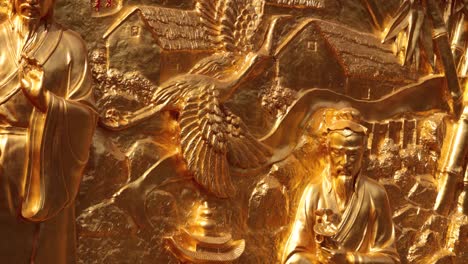 intricate gold sculpture depicting taoist themes