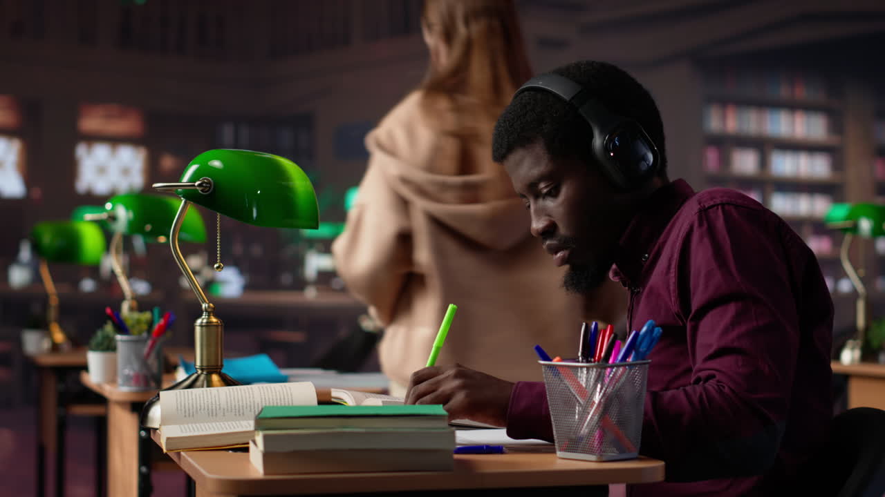 Vertical video black guy using study music to help with deep focus for academic success