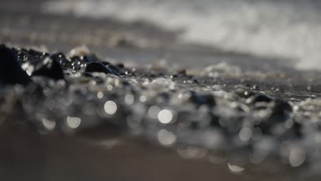 ocean waves crashing on pebbles