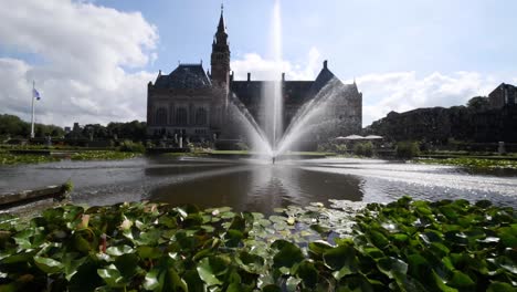 garden of the peace palace, the seat of the international court of justice under a sunny and cloudy summer day