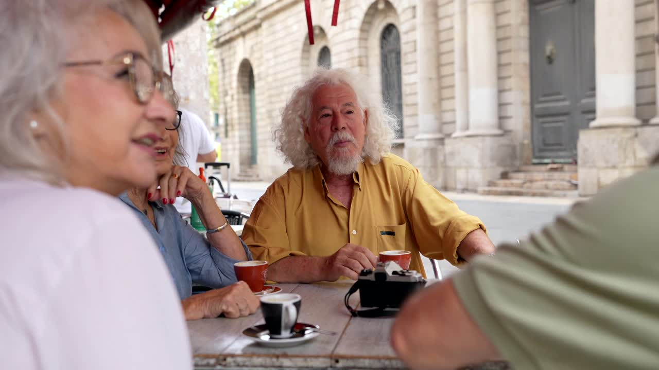 Elderly People Enjoying Coffee and Conversation at Outdoor Cafe