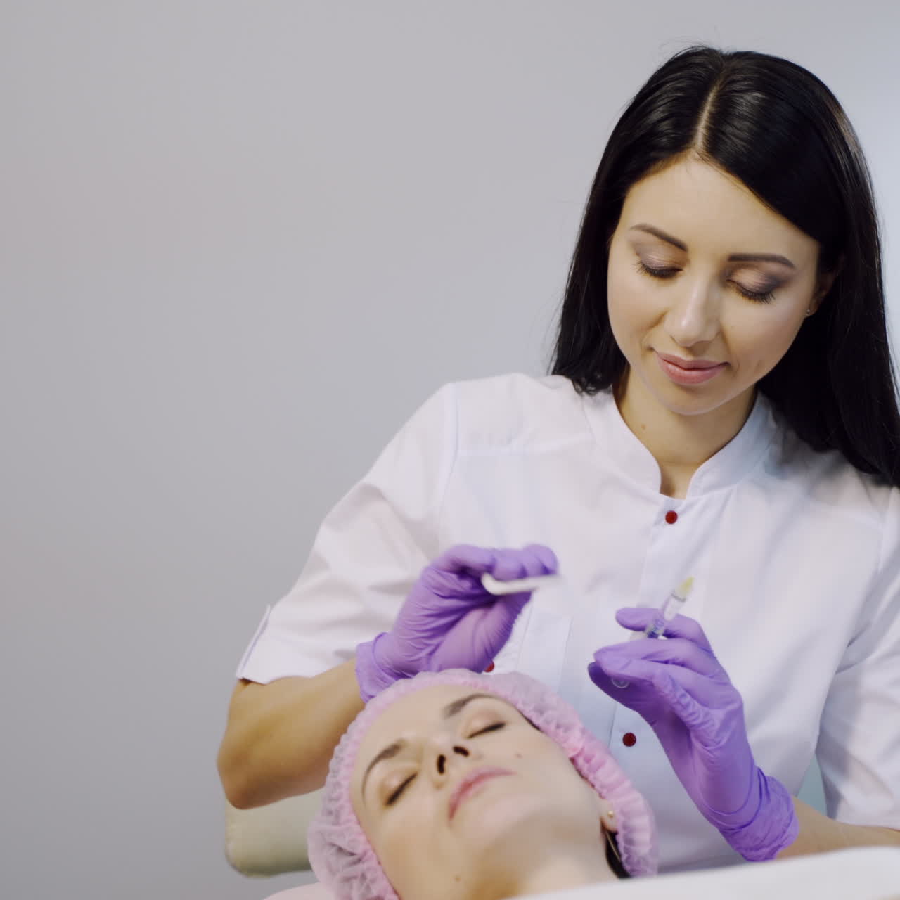 A woman on the procedure of injections in a cosmetology clinic. Preventing wrinkles.