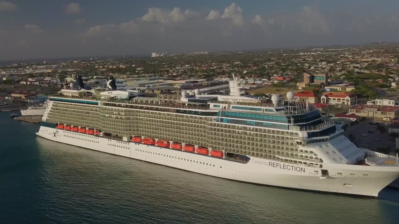 Aerial establishing shot of the cruise ship in dock which illustrates how big the ship is