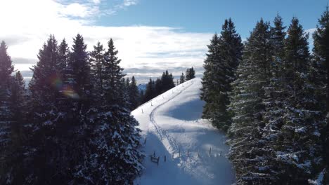 Revealing-a-beautiful-snowy-hill-with-mountains-in-the-background