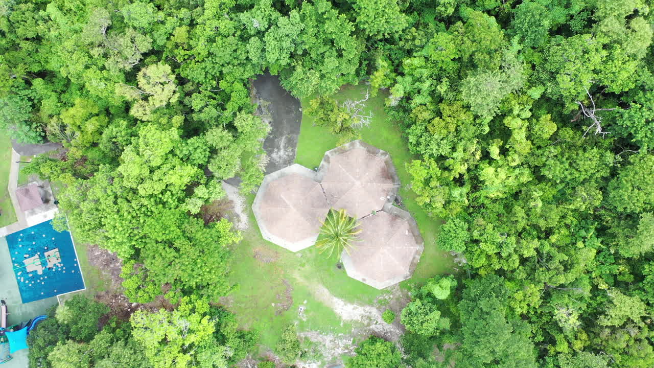 Cinematic spinning top-down aerial bird's eye view of park shelter